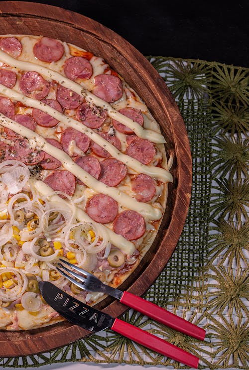 Top View of a Pizza on a Round Cutting Board 