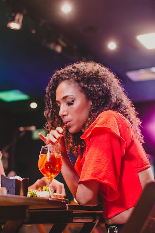 Woman Drinking a Cocktail in a Nightclub 