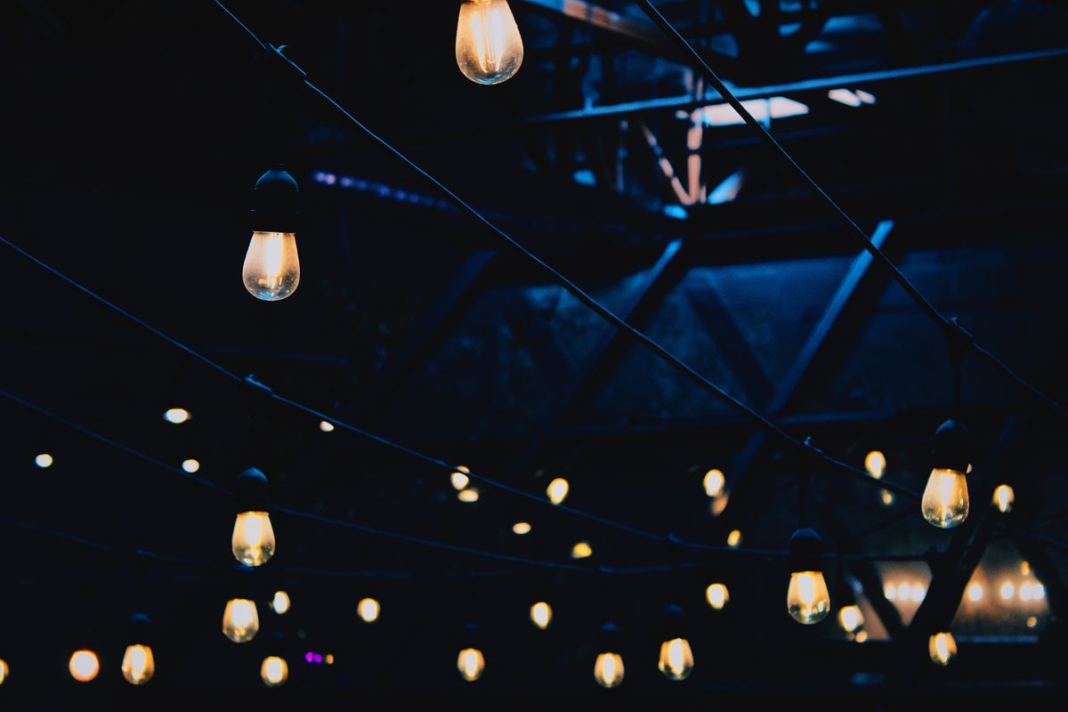 Warm string lighting installed inside a modern event space