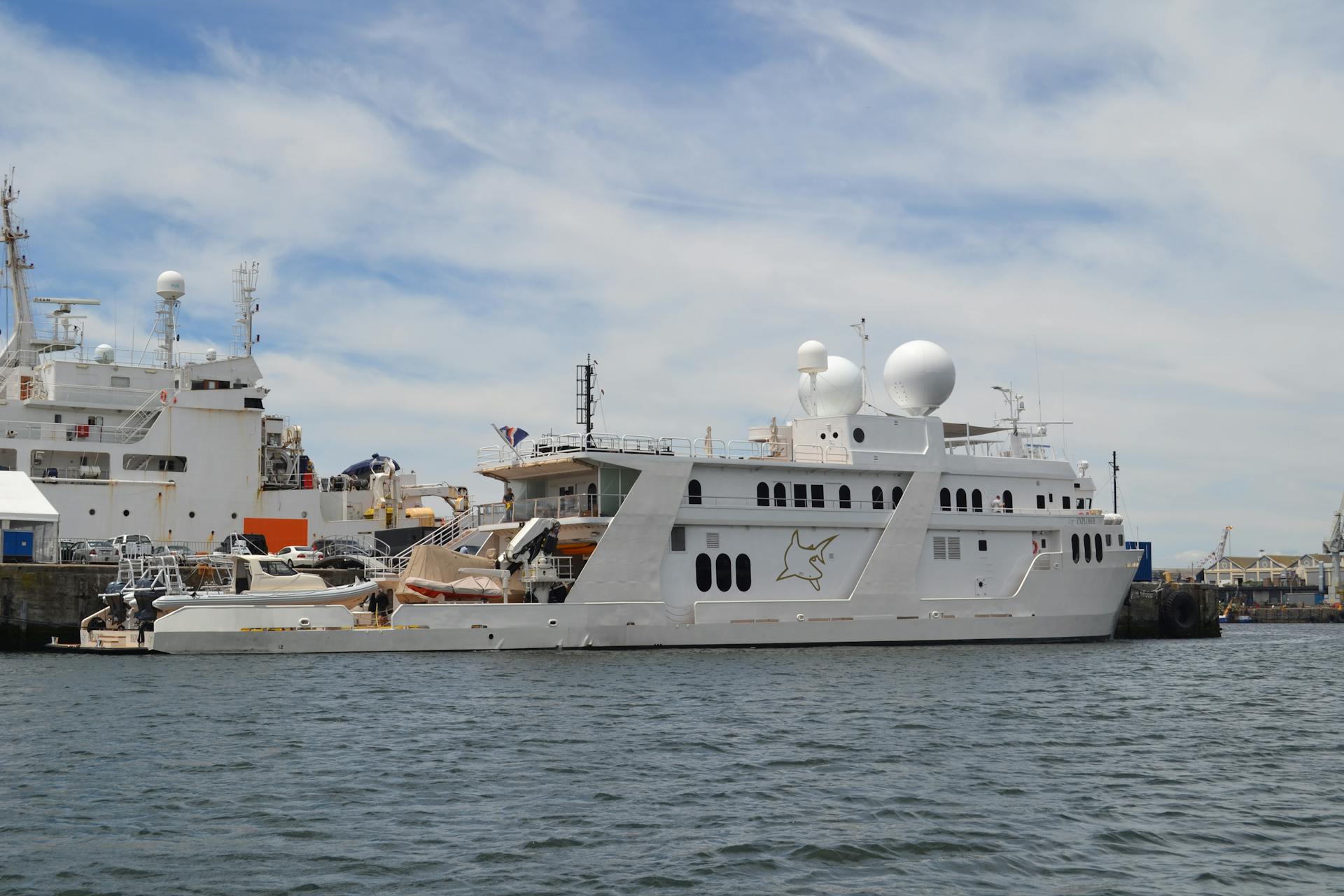 A luxury yacht moored in Cape Town harbor, showcasing wealth and maritime beauty.