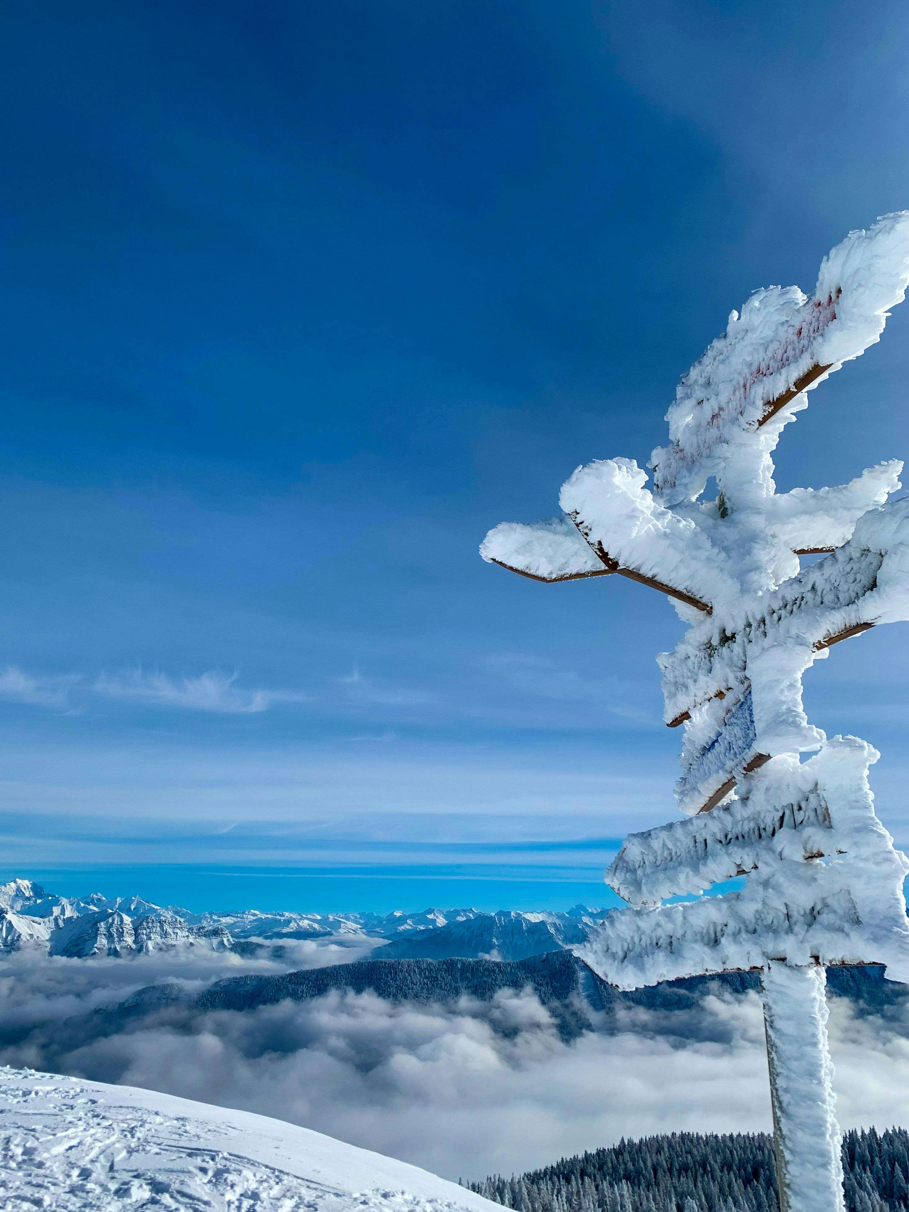 Prescription Goggle Inserts - A stunning winter scene in Annecy showcases a snow-covered signpost with the majestic Alps in the background.