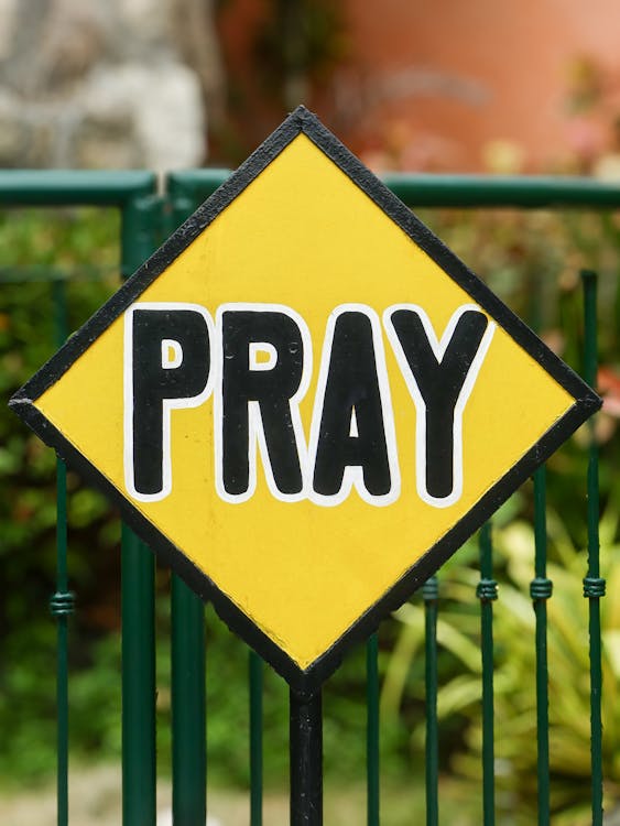 Pray Written on Yellow Sign · Free Stock Photo
