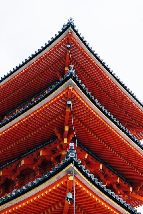 A tall pagoda with red and orange decorations