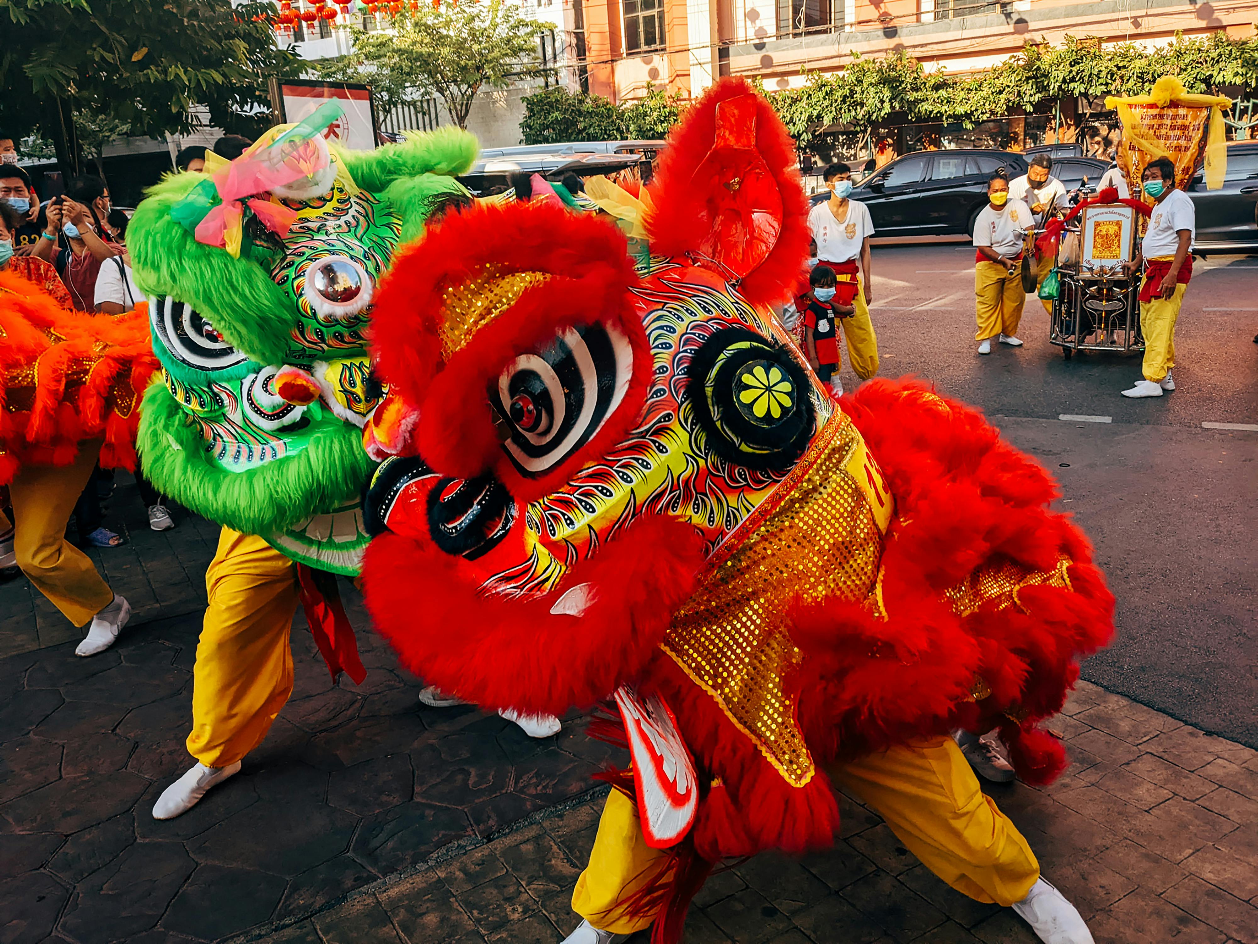 Free Colorful dragon dance performance during a street festival in Bangkok, showcasing vibrant cultural traditions. Stock Photo