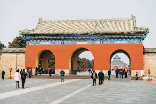 People walking in front of an archway in china