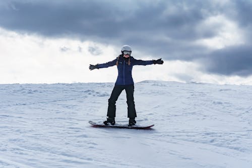 Free Woman on Snowboard on Ski Slope in Krynica, Poland Stock Photo