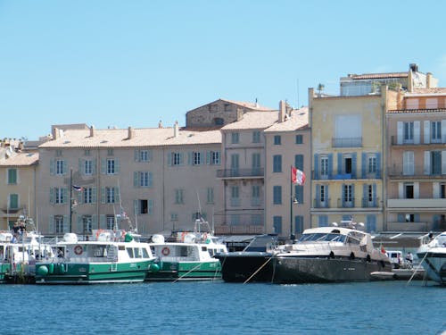 Motor Yacht and Motorboats Moored on Sea Shore in City