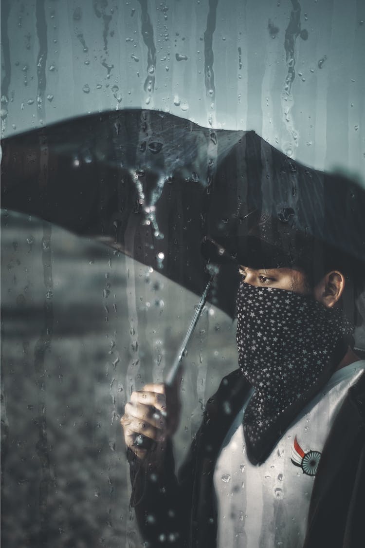 Woman Carrying Black Umbrella