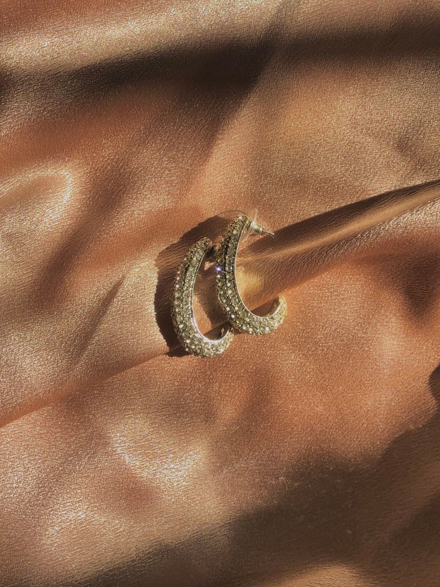 Gold hoop earrings on satin with diamond embellishments