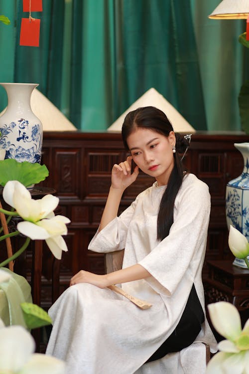 Woman Sitting in Traditional Clothing 