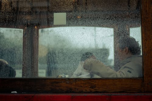 Passenger behind Window in Rain