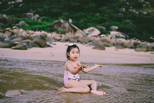 Girl Sitting on Seashore