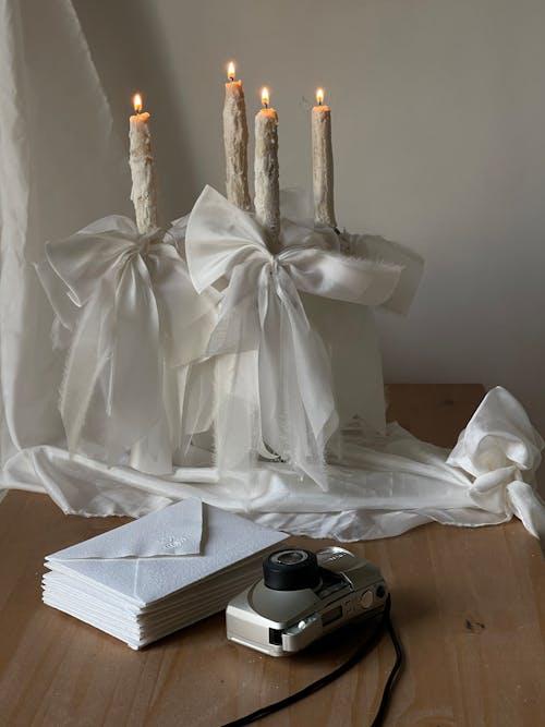 Stack of Envelopes, a Camera and Decorative Candles