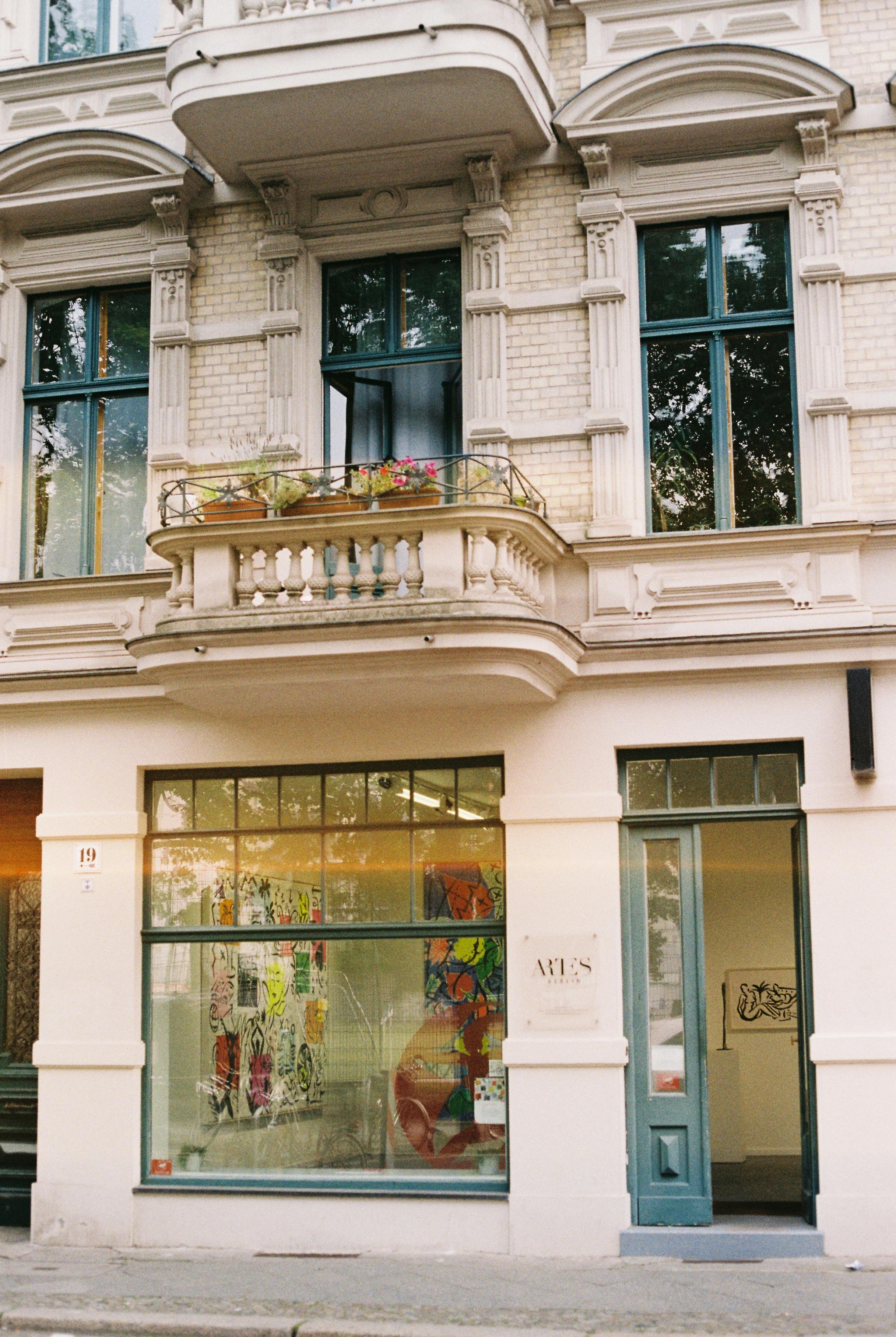 Elegant vintage building in Berlin with art gallery and charming balcony.