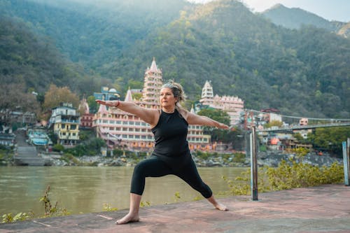 Exercising at the River Ganges Near the Hindu Temple of Trimbakeshwar Om Shiv Pooja Bhandar w Rishikesh