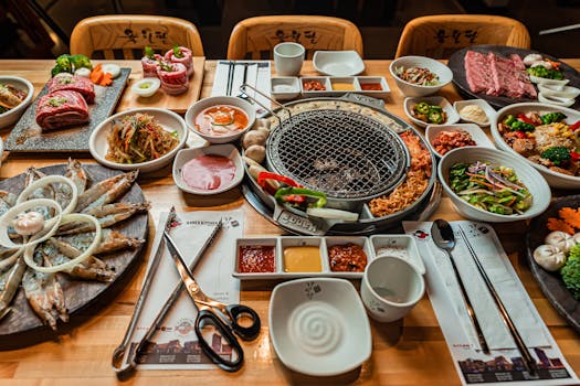 Delicious Korean barbecue spread with a variety of dishes served on a wooden table, perfect for food lovers.