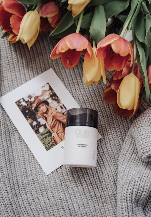 Flowers, Jar of Cream and Picture of Woman