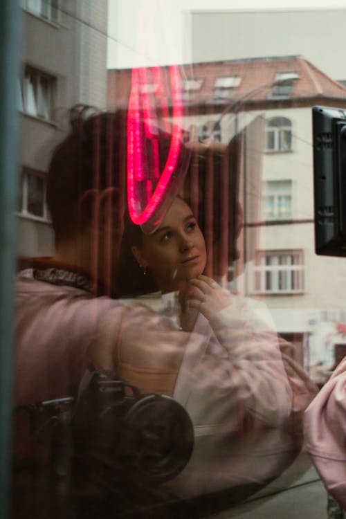 Woman, Man, Camera and Building behind Window