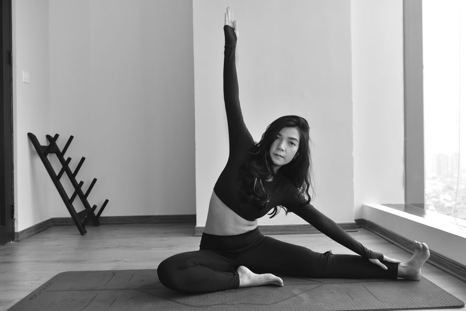 woman stretching yoga studio floor