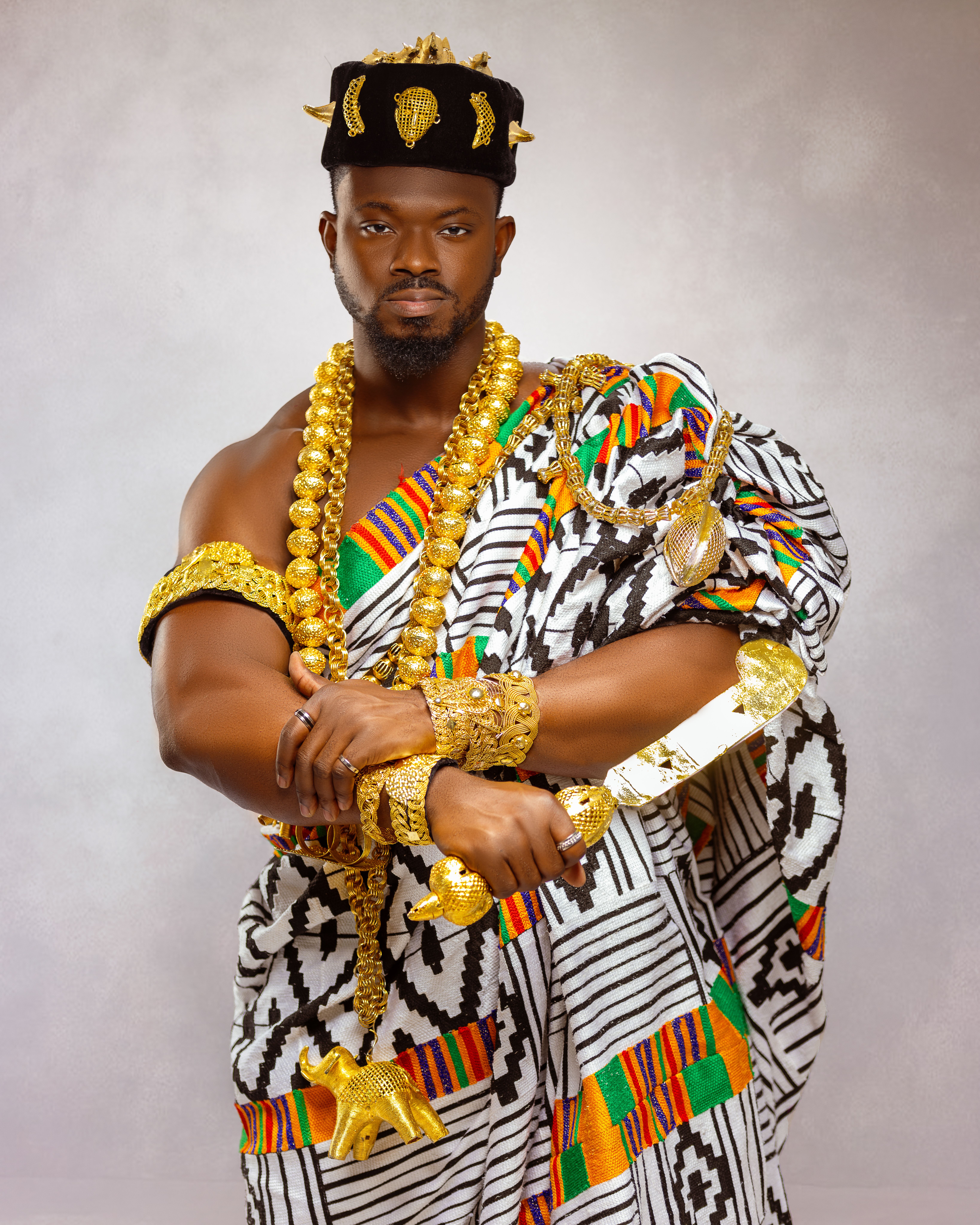 A powerful portrait of an African man adorned in traditional tribal attire with ornate jewelry, showcasing cultural heritage.