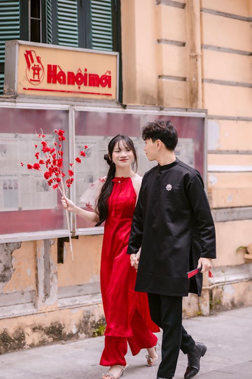 Smiling Couple Walking in Traditional Clothing 