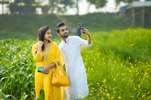 Couple Taking a Picture on a Field in India 