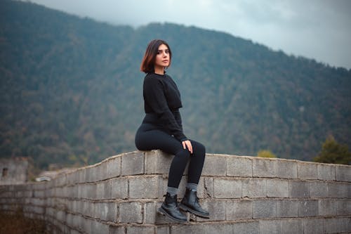 Woman Sitting on Wall
