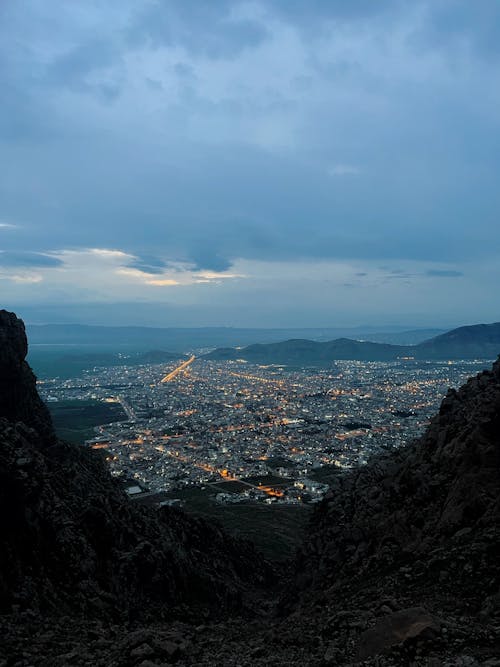 Rocky Hill over City under Cloud