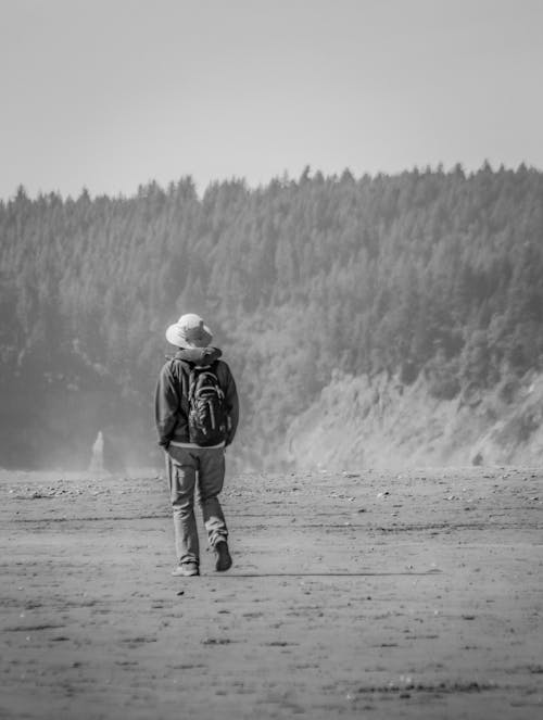 Back View of Man Walking with Backpack