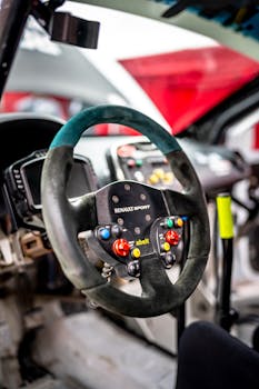 Detailed view of a racing car's steering wheel and cockpit interior.