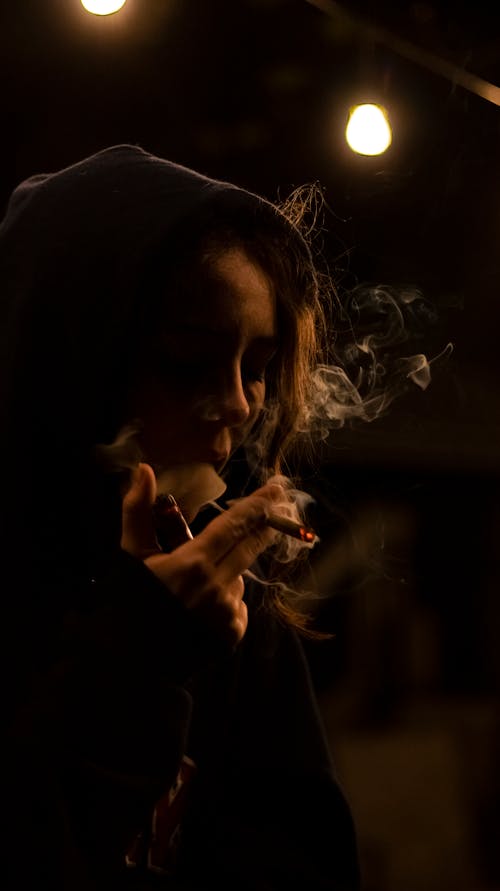 Woman Smoking Cigarette at Night