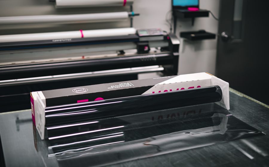 Glossy roll of print vinyl stocked in a sticker printing shop