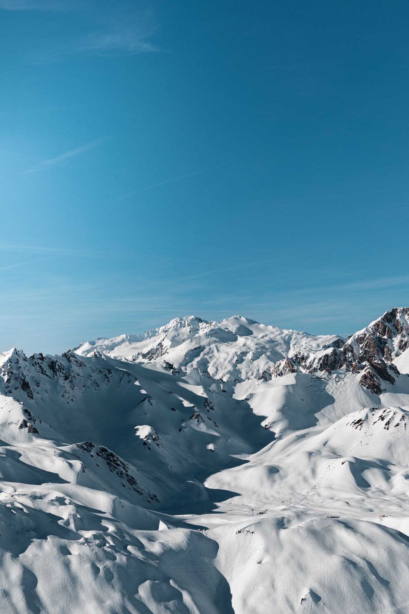 Snow-covered mountains under a clear blue sky at Val-d'Isère, France, in winter (photo taken 27 January 2024).