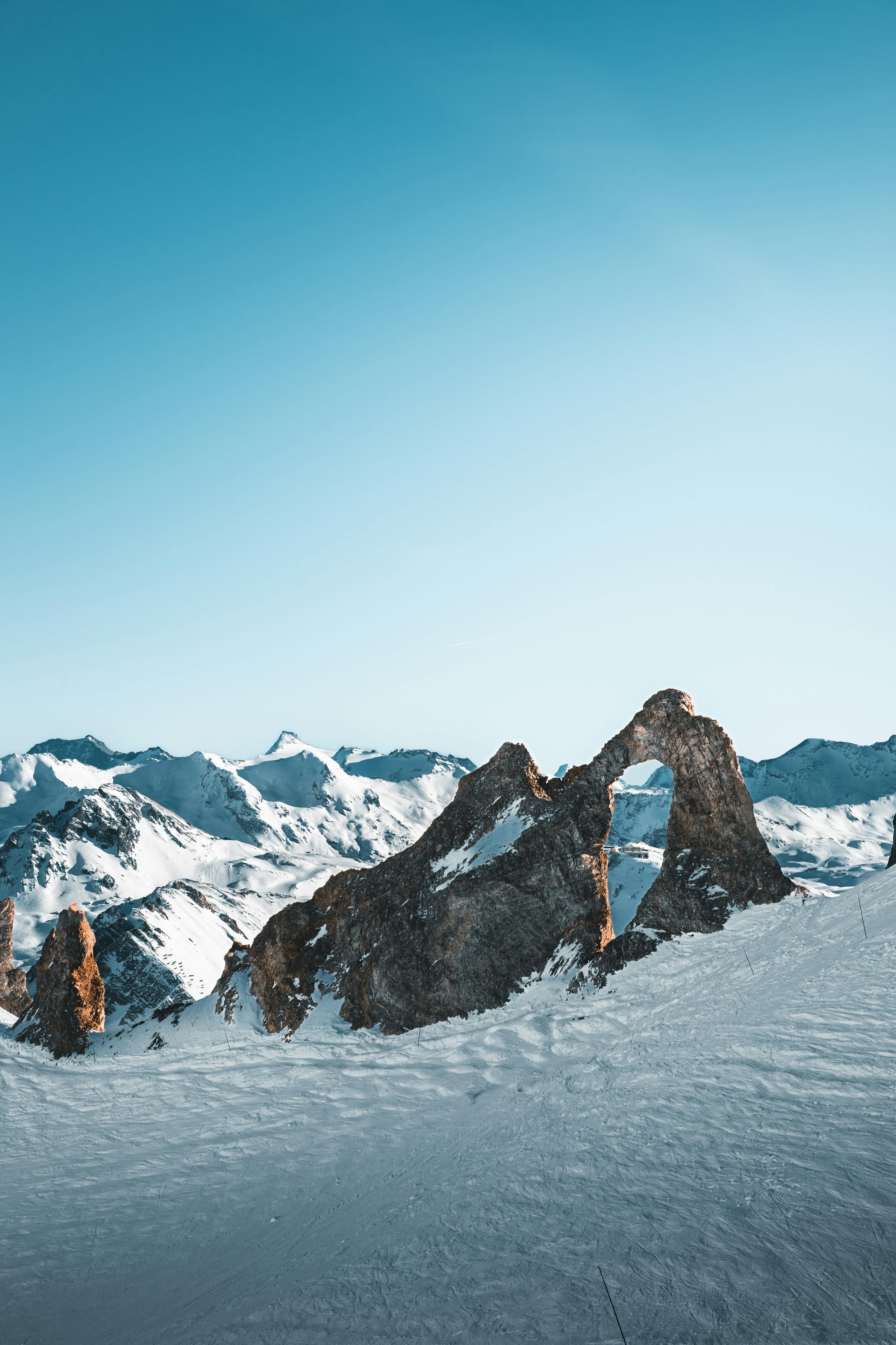 a person standing on top of a mountain with snow