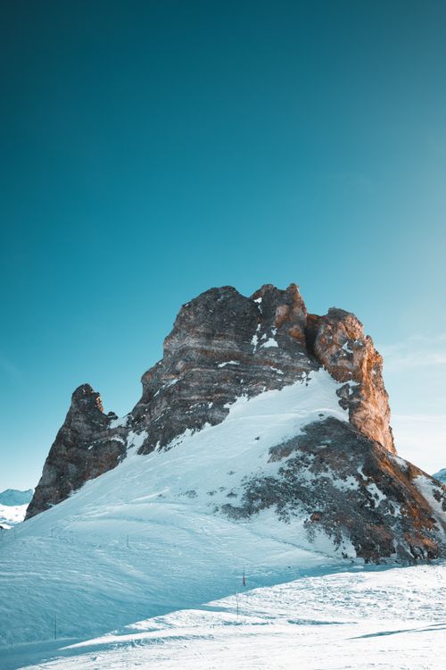 A person standing on top of a mountain with snow · Free Stock Photo