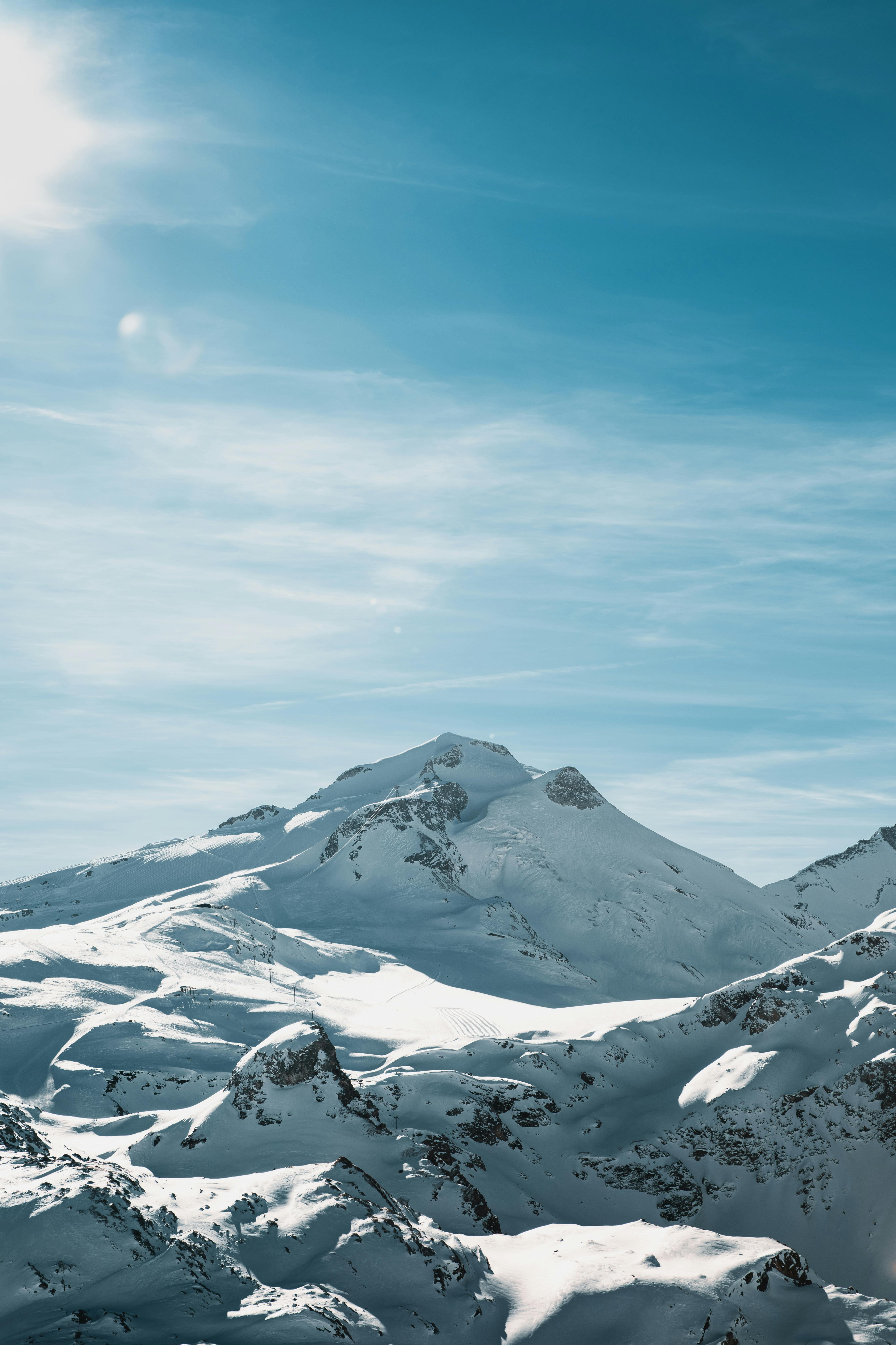 a snow covered mountain with a blue sky