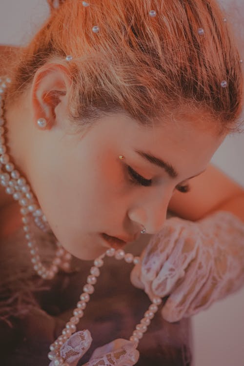 Young Woman Wearing Pearls and Lace Gloves 