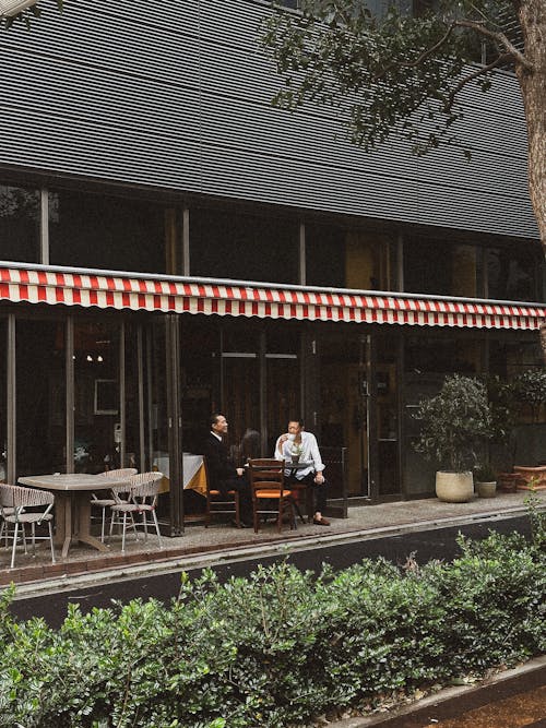 Men Sitting on Terrace at Cafe and Drinking