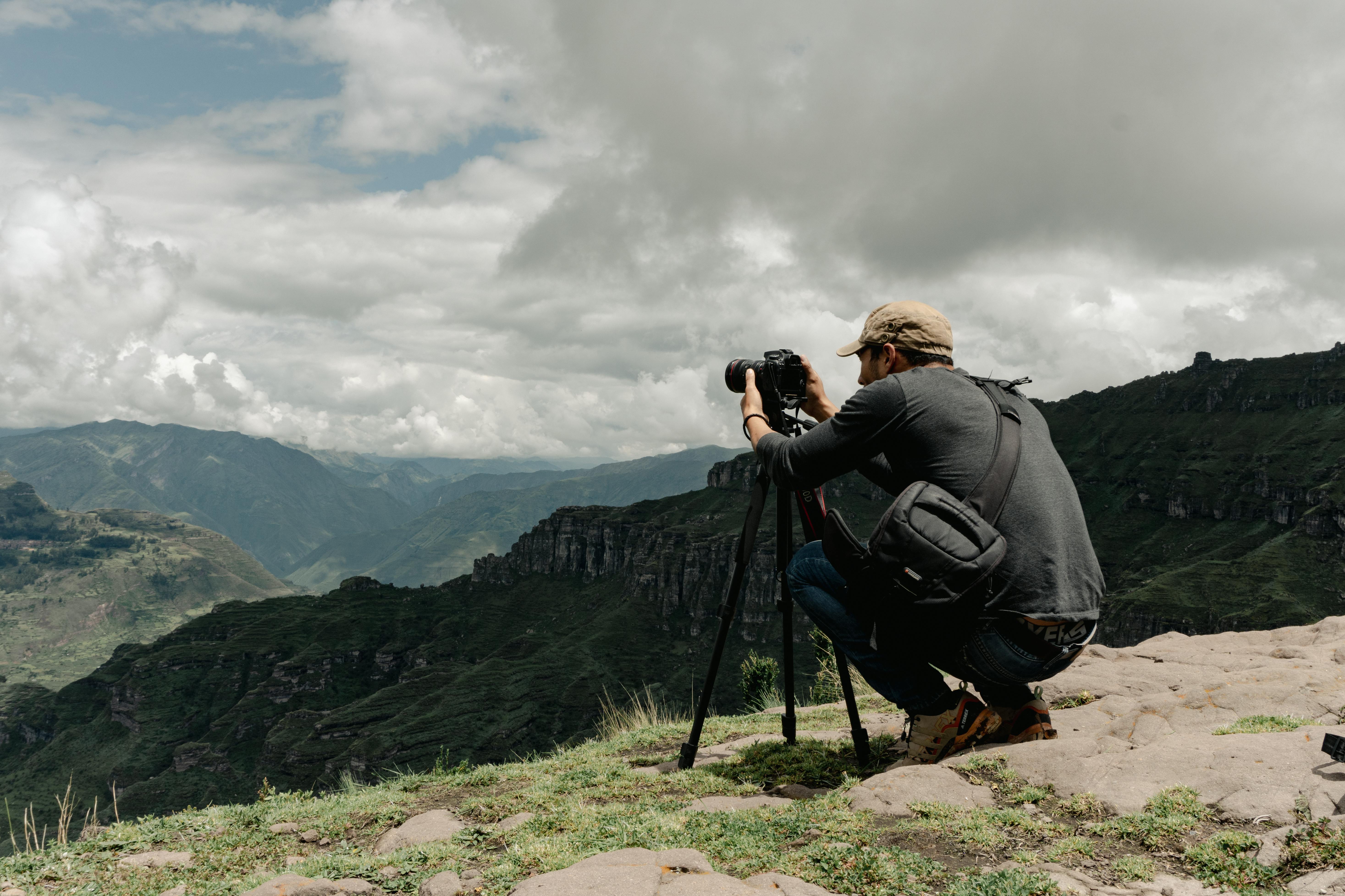 man photographing waqrapukara