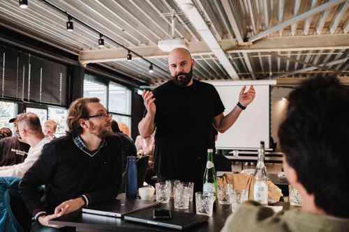 Free A team of colleagues engaged in a lively discussion in a modern office environment. Stock Photo