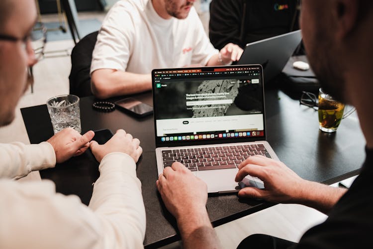 Hands Of Men Working On Laptop