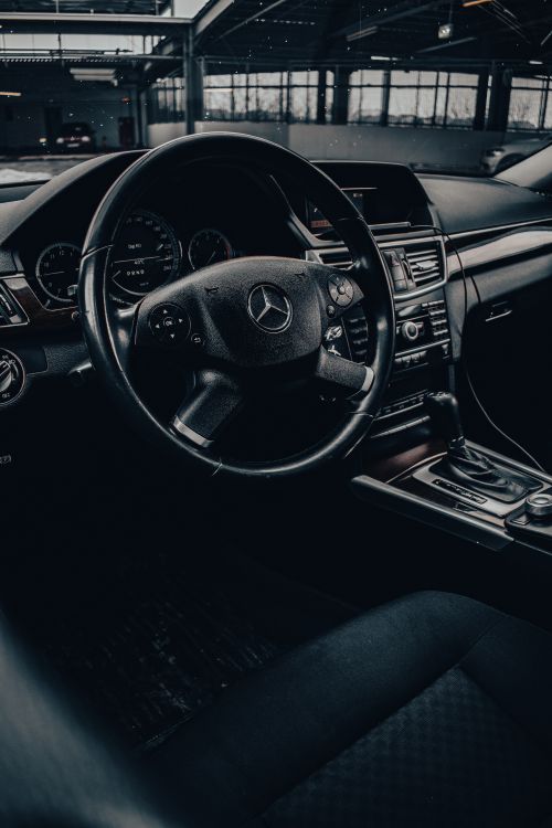 Free Sleek car interior showcasing luxury design and elegant steering wheel detail. Stock Photo