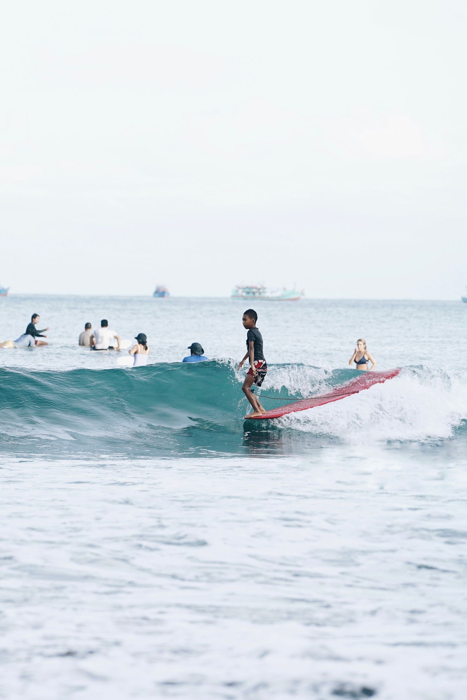 Young surfer riding a wave in the ocean