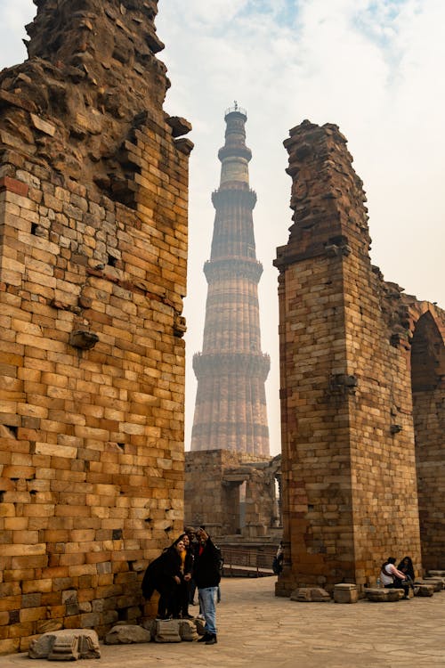 People Taking Selfie Near Qutb Minar in Delhi, India