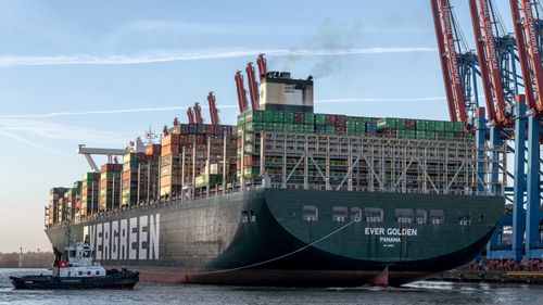 Free Container ship Evergreen Ever Golden docked at Hamburg port. Stock Photo