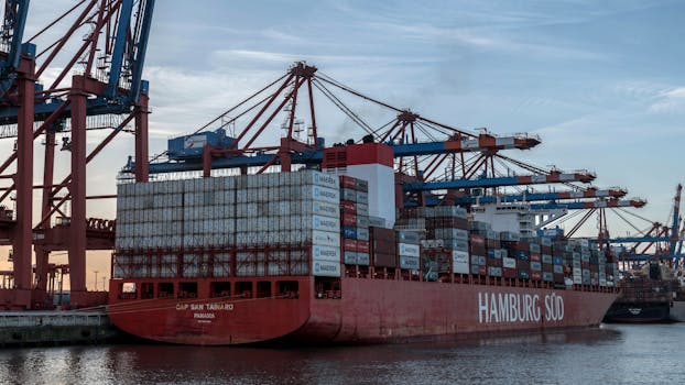 Massive container ship docked at Hamburg Port, showcasing logistics and global trade.