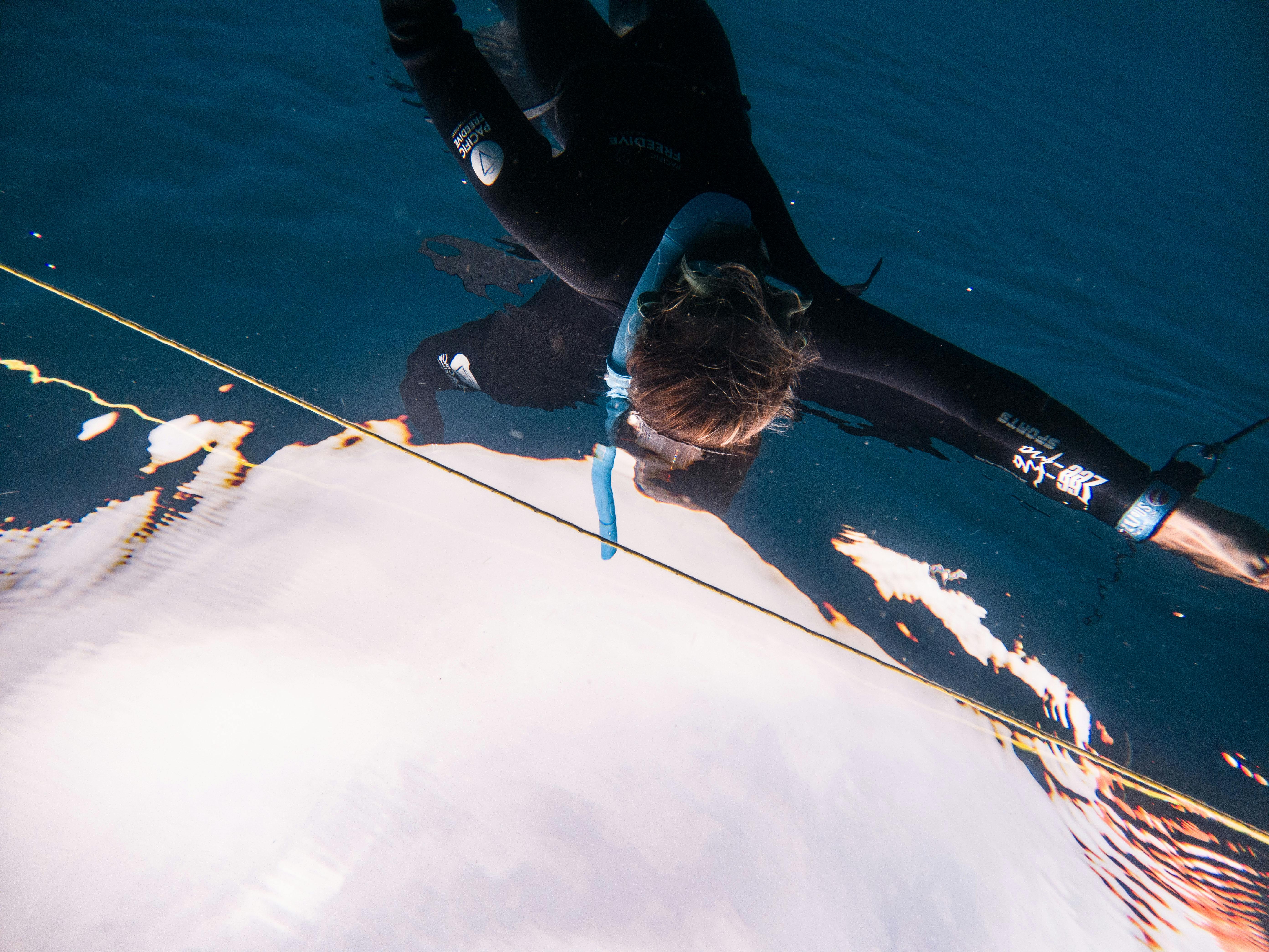Close-up shot of a diver underwater, capturing movement in a serene sea setting.