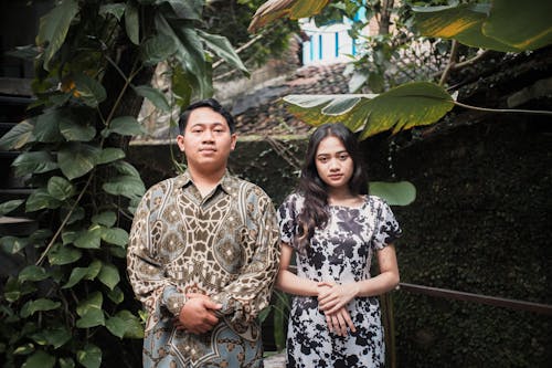 A Couple Posing Against Foliage