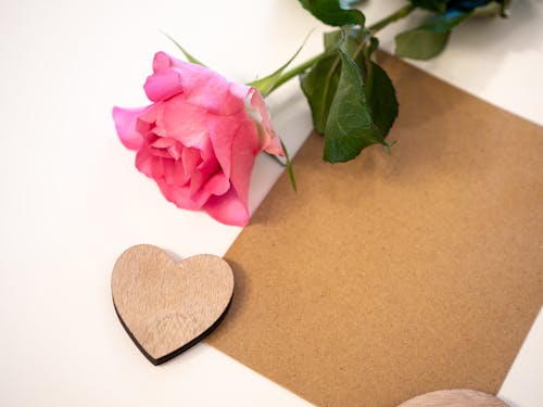 Blank Board Decorated with Wooden Heart and Pink Rose