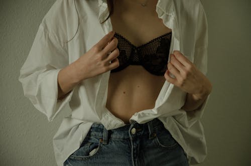 Undressing Woman Showing Black Bra